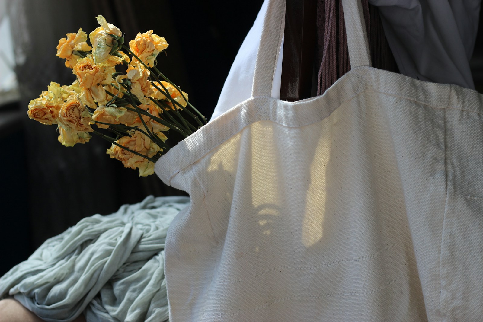 white textile near yellow flowers